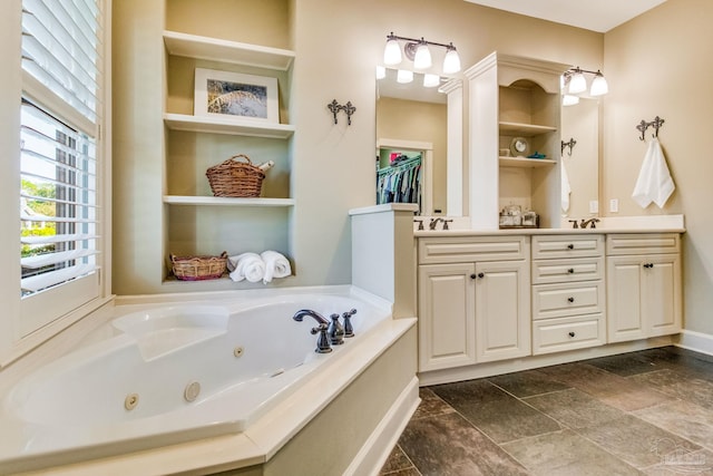 bathroom featuring a tub to relax in and vanity