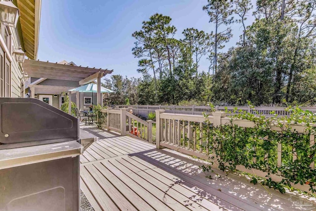 deck featuring a pergola and a grill