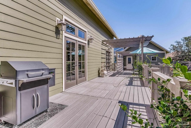 deck featuring a pergola and french doors