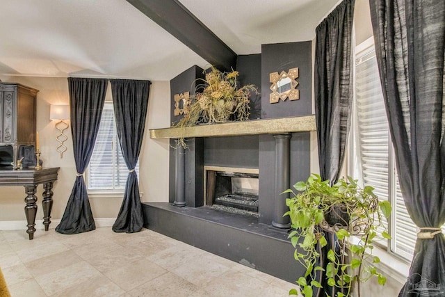 4552 Bayside Dr, Milton, FL 32583 - details featuring beamed ceiling, baseboards, and a glass covered fireplace