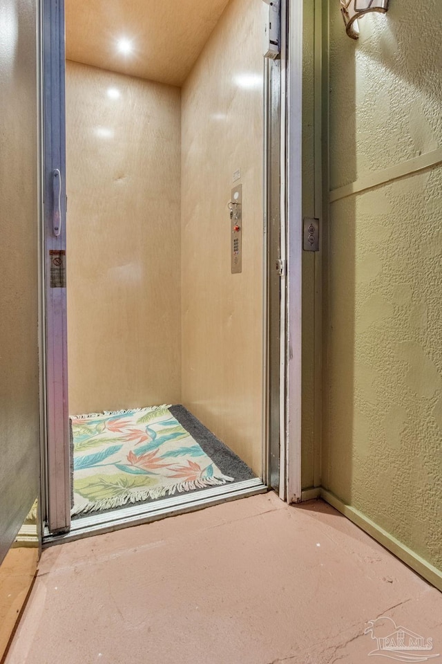 4552 Bayside Dr, Milton, FL 32583 - room details featuring elevator and a textured wall