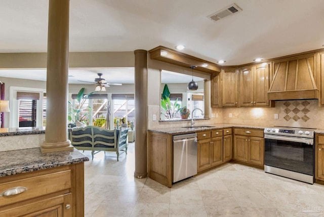 4552 Bayside Dr, Milton, FL 32583 - kitchen with visible vents, premium range hood, stainless steel appliances, ornate columns, and a sink
