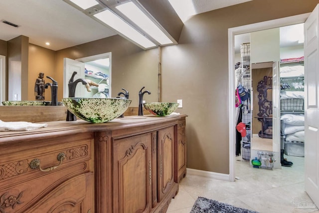 4552 Bayside Dr, Milton, FL 32583 - bathroom featuring visible vents, baseboards, vanity, and tile patterned flooring