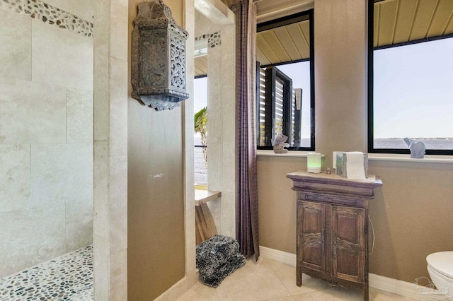 4552 Bayside Dr, Milton, FL 32583 - full bathroom featuring tile patterned flooring, baseboards, toilet, and walk in shower