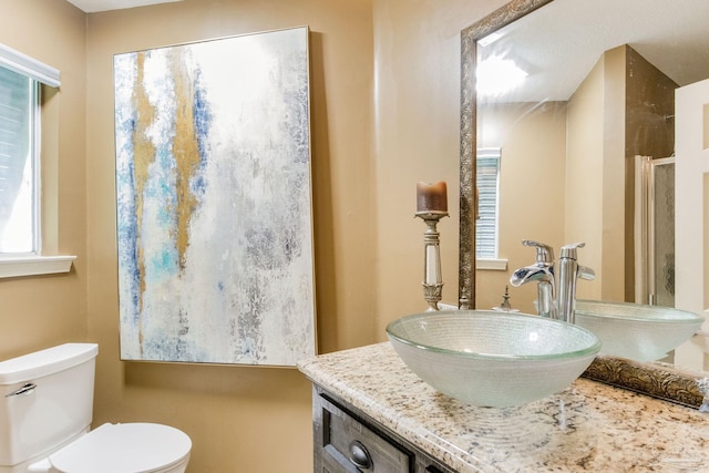 4552 Bayside Dr, Milton, FL 32583 - bathroom featuring vanity, toilet, and a shower with shower door