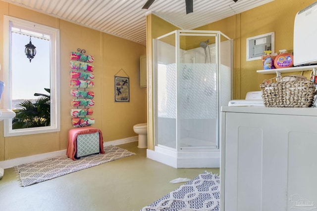 4552 Bayside Dr, Milton, FL 32583 - full bathroom featuring toilet, a stall shower, a ceiling fan, washer / clothes dryer, and finished concrete floors