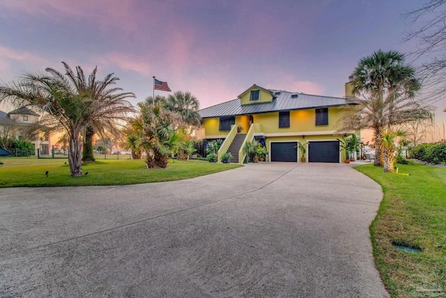 4552 Bayside Dr, Milton, FL 32583 - view of front of home featuring a front lawn, stairs, metal roof, an attached garage, and a standing seam roof