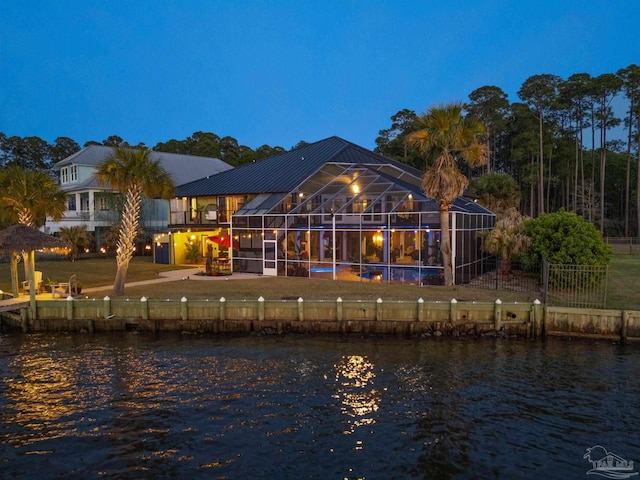 4552 Bayside Dr, Milton, FL 32583 - back of property with a fenced in pool, a water view, a lanai, metal roof, and a patio area