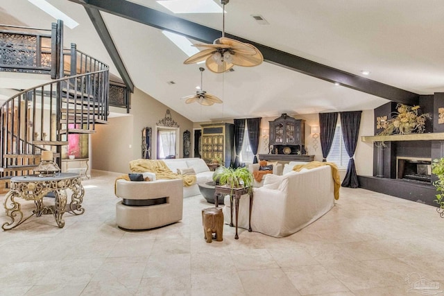 4552 Bayside Dr, Milton, FL 32583 - living area with visible vents, stairway, beam ceiling, a skylight, and a ceiling fan