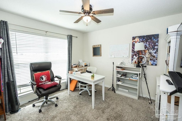 carpeted office space with ceiling fan