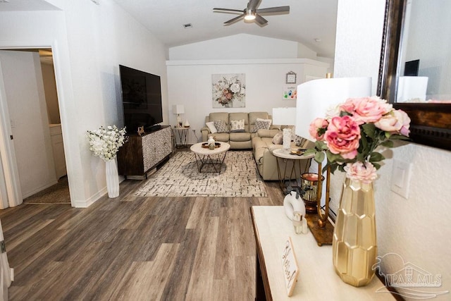 living room featuring ceiling fan, hardwood / wood-style floors, and vaulted ceiling