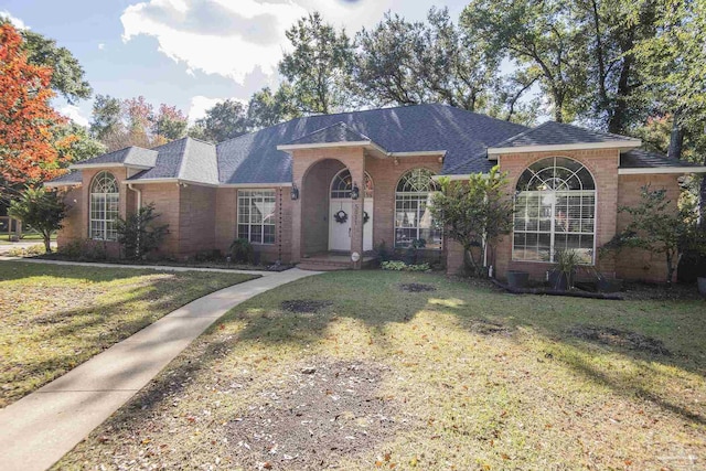 ranch-style house with a front lawn