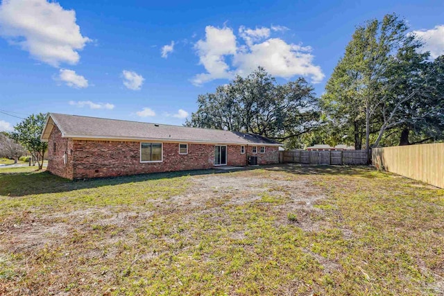 720 Lambert St, Pensacola, FL 32505 - rear view of house with a yard, fence, and brick siding