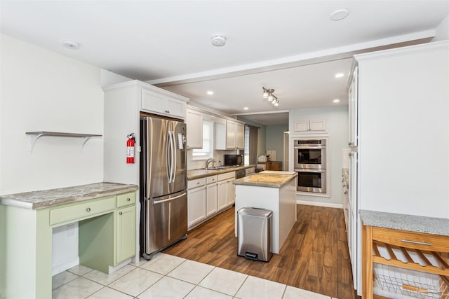 720 Lambert St, Pensacola, FL 32505 - kitchen with recessed lighting, light countertops, a kitchen island, stainless steel appliances, and a sink