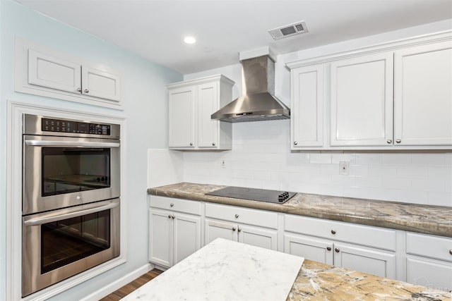 720 Lambert St, Pensacola, FL 32505 - kitchen featuring dark wood-style flooring, visible vents, wall chimney exhaust hood, black electric cooktop, and double oven