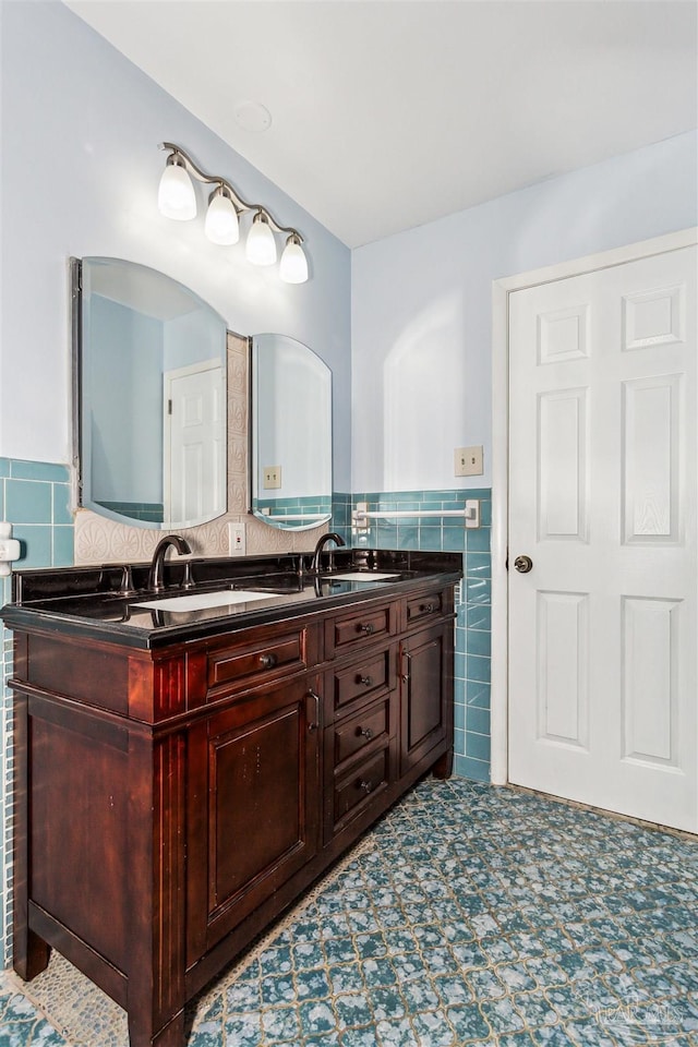 720 Lambert St, Pensacola, FL 32505 - full bath featuring a sink, tile walls, double vanity, and a wainscoted wall
