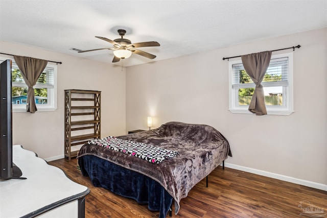 720 Lambert St, Pensacola, FL 32505 - bedroom featuring multiple windows, baseboards, and dark wood finished floors