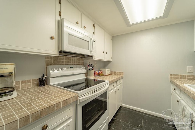 kitchen featuring white cabinets, white appliances, tile counters, and backsplash