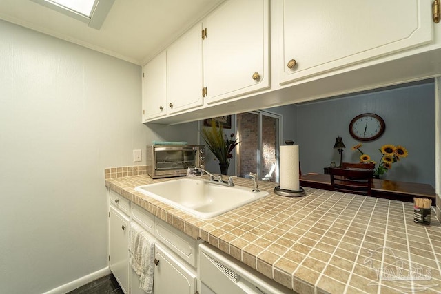 laundry room with crown molding and sink