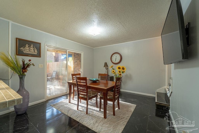 dining space featuring crown molding and a textured ceiling