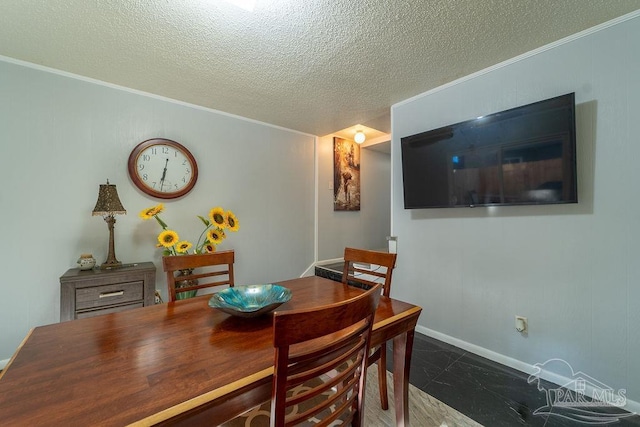 dining room featuring crown molding and a textured ceiling