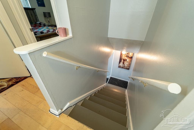 stairs with wood-type flooring