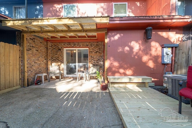 rear view of property with central AC unit and a patio area