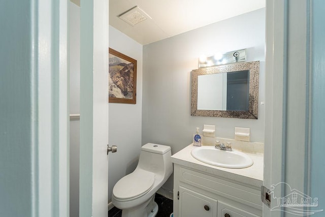 bathroom featuring vanity and toilet