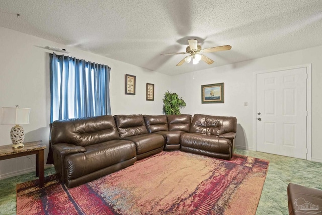 carpeted living room featuring a textured ceiling and ceiling fan