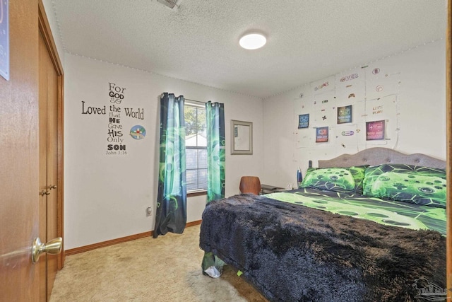 bedroom featuring light carpet and a textured ceiling