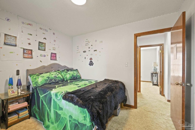 carpeted bedroom featuring a textured ceiling