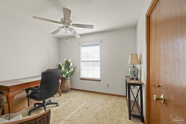 home office with light carpet, ceiling fan, and a textured ceiling