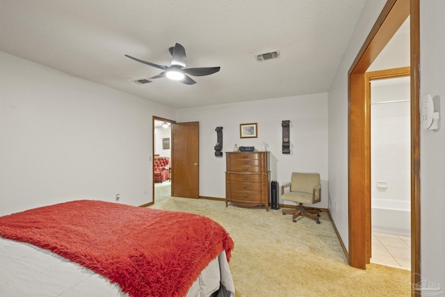 bedroom featuring carpet, a textured ceiling, connected bathroom, and ceiling fan