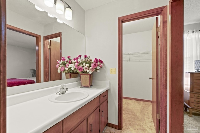 bathroom with a textured ceiling and vanity