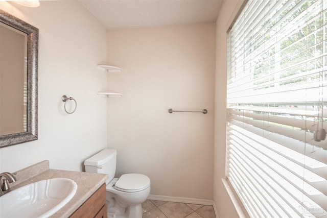 bathroom featuring vanity, tile patterned floors, and toilet