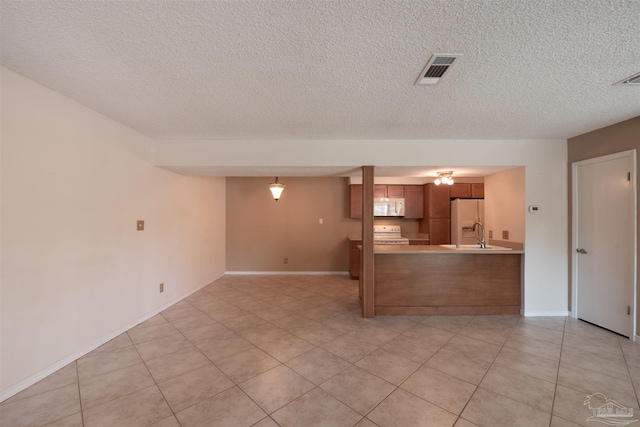 unfurnished living room featuring light tile patterned floors and a textured ceiling