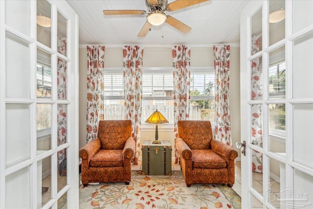 living area with french doors, ceiling fan, and tile patterned floors