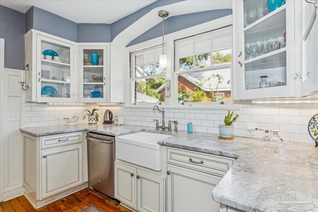 kitchen featuring dark wood-style flooring, a sink, light stone countertops, tasteful backsplash, and pendant lighting