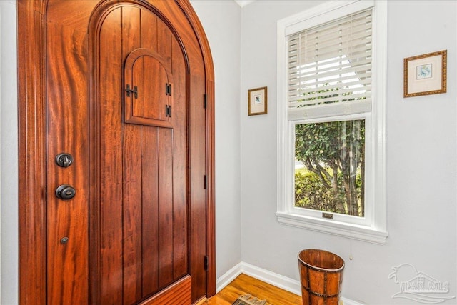 interior space with baseboards and wood finished floors