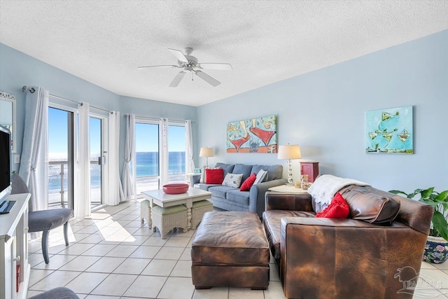 22 Via Deluna Dr Unit 604, Pensacola Beach, FL 32561 - living area with a ceiling fan, light tile patterned floors, a textured ceiling, and a water view