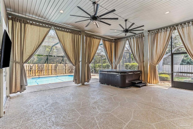 sunroom / solarium featuring a jacuzzi, plenty of natural light, and ceiling fan