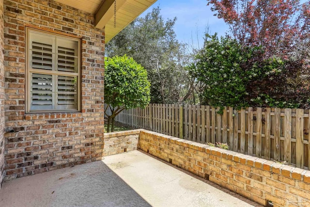 view of patio / terrace featuring fence