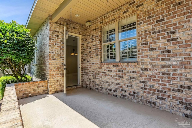 property entrance featuring brick siding
