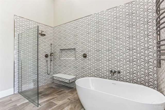 bathroom with walk in shower and a soaking tub
