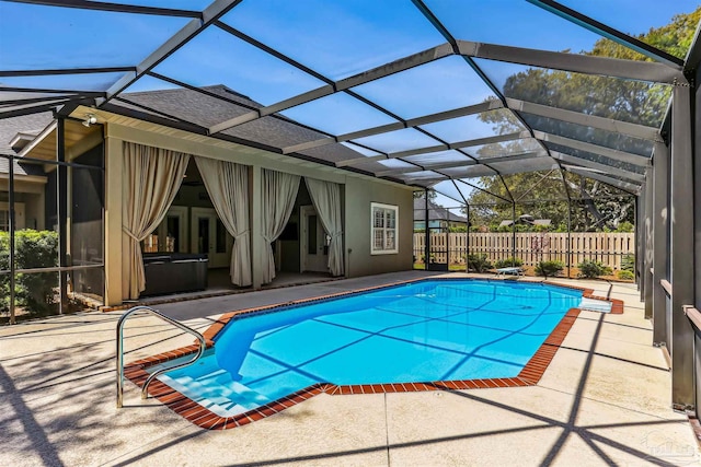 view of pool featuring glass enclosure, a fenced in pool, a fenced backyard, and a patio