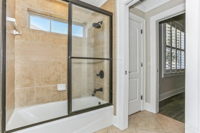 full bath with tile patterned floors, baseboards, and bath / shower combo with glass door