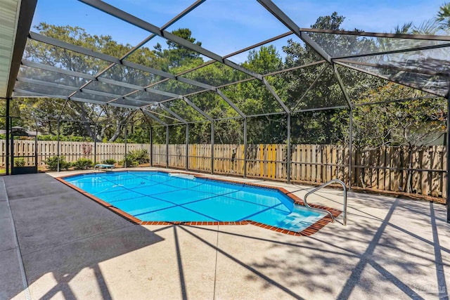 view of swimming pool with a fenced backyard, a patio, a fenced in pool, and glass enclosure