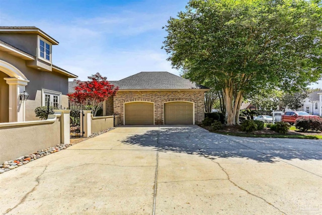 view of front of property with driveway, fence, a garage, stucco siding, and brick siding