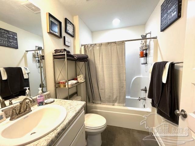 full bathroom with toilet, shower / bath combo with shower curtain, and vanity