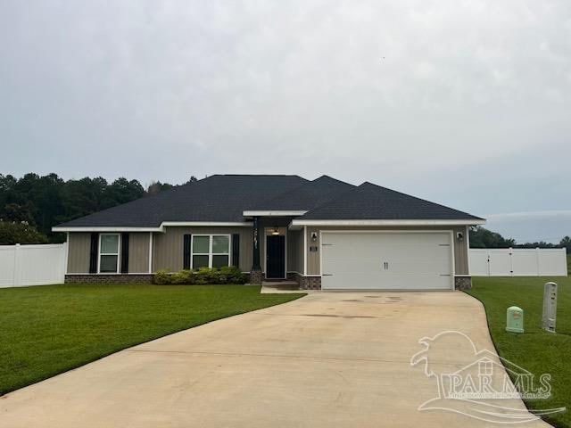 ranch-style home featuring a garage and a front lawn